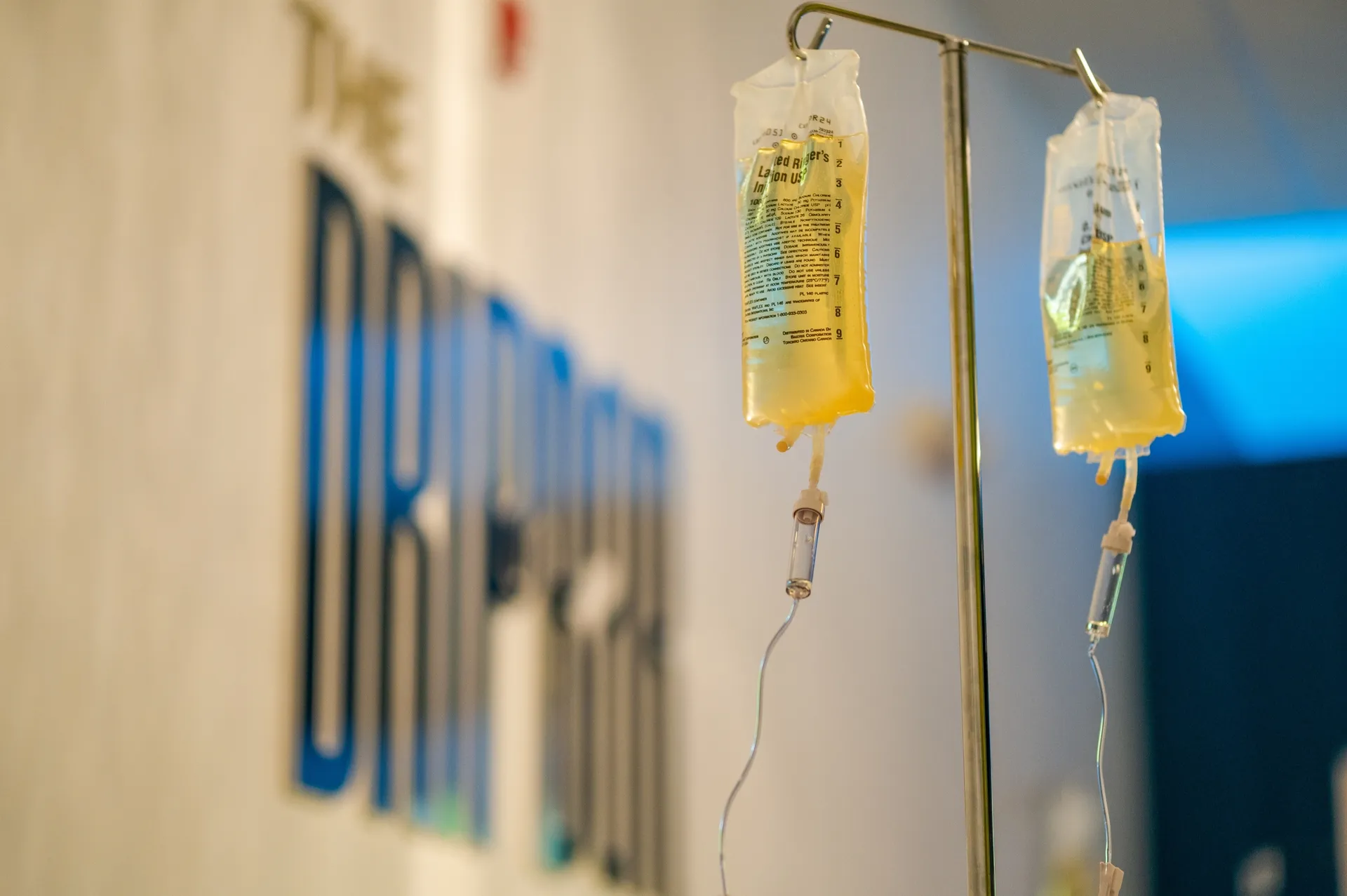 IV bags hanging in front of the DRIPBaR logo