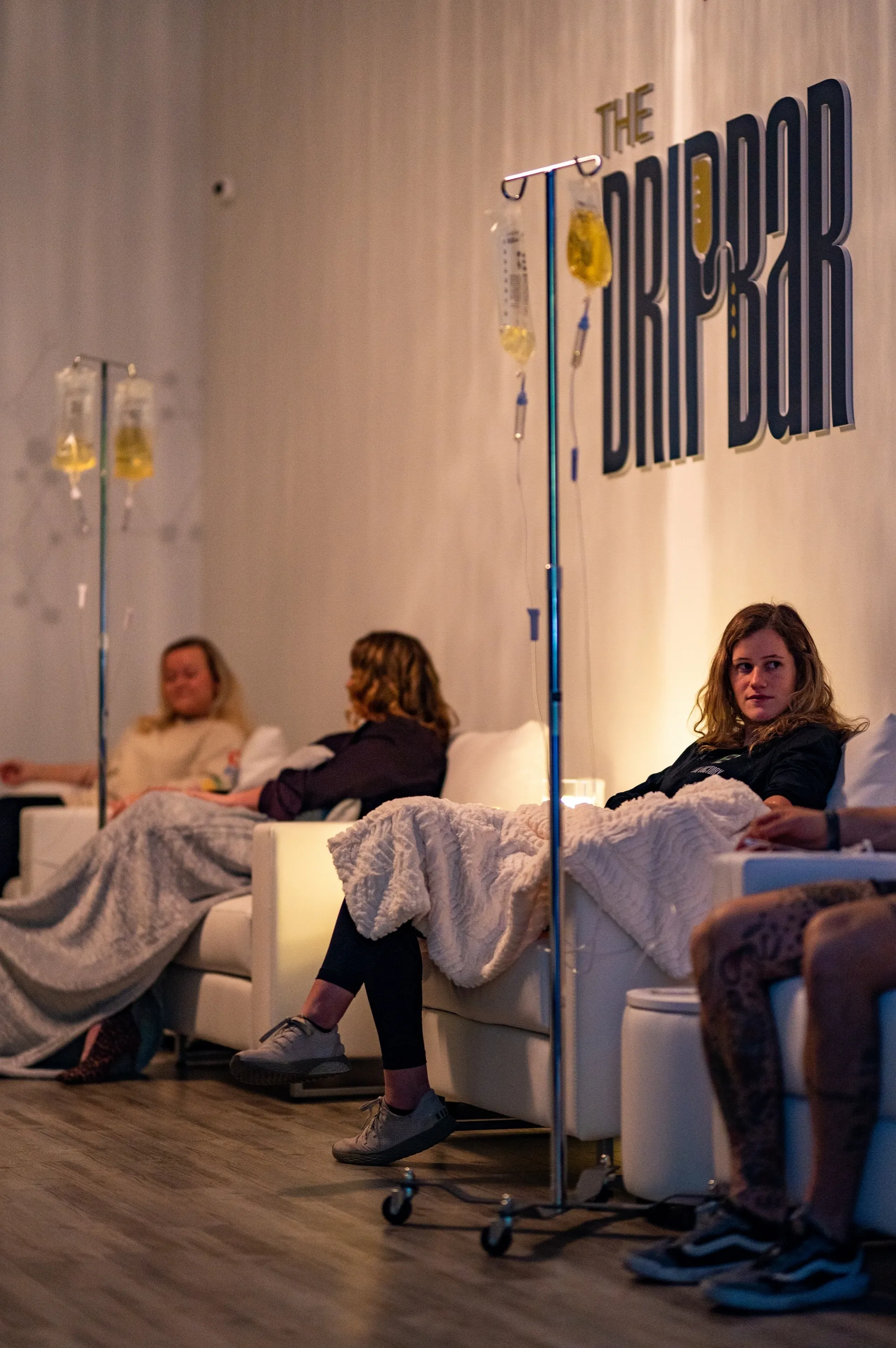 Clients relaxing with blankets during evening drips